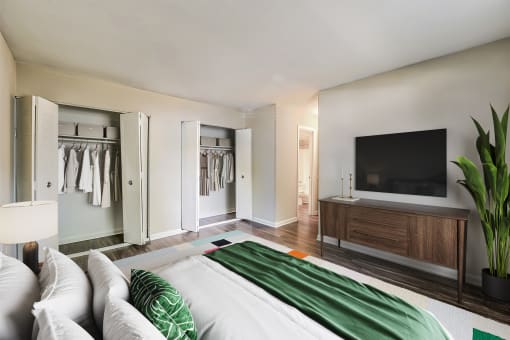 a bedroom with a large bed and a tv