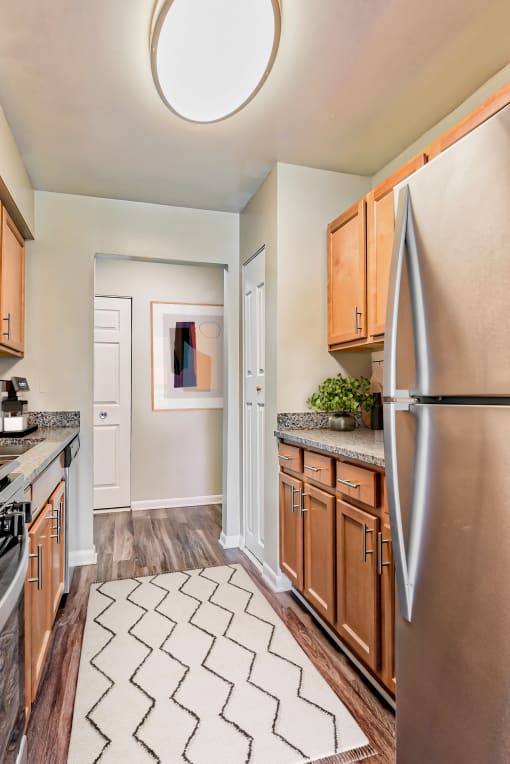 a kitchen with wood cabinets and stainless steel appliances