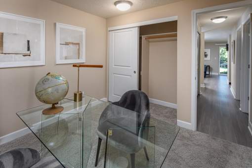 a dining room with a glass table and chairs