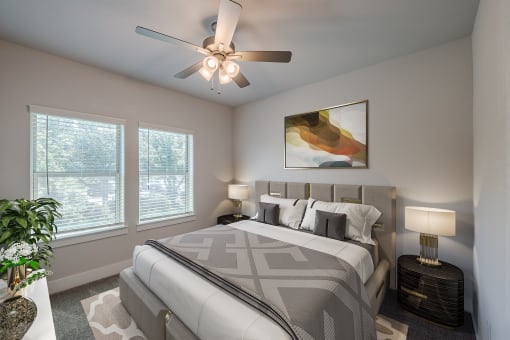a bedroom with a large bed and a ceiling fan