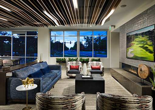 A modern living room with a large window overlooking a street.