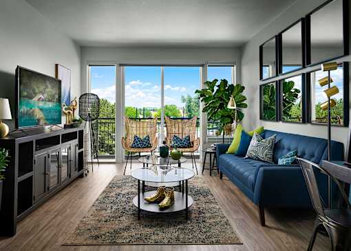 A living room with a blue couch and a coffee table.
