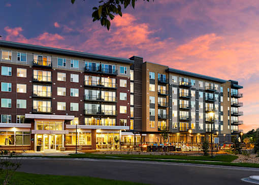A large apartment building with a lot of windows and balconies.