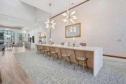 A long white table with chairs on it.