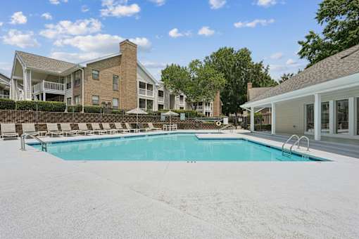 A large swimming pool in front of a building.