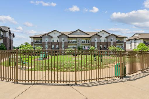 A large apartment complex with a playground in the front.