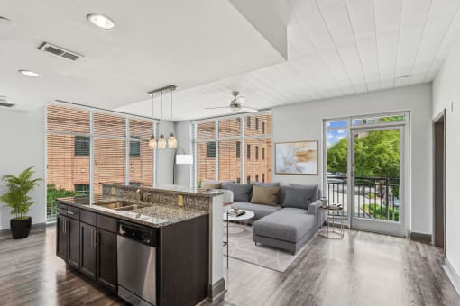 a living room with a kitchen and a sliding glass door