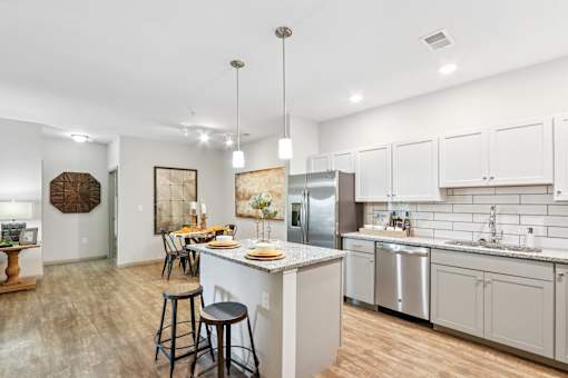 A kitchen with a bar stool and a counter.