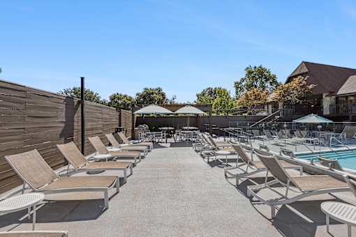 A poolside area with sun loungers and a pool.