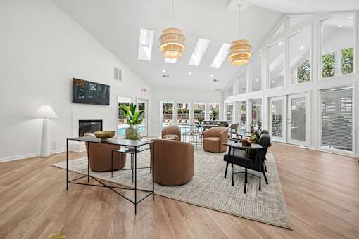 A modern living room with a glass table and chairs.