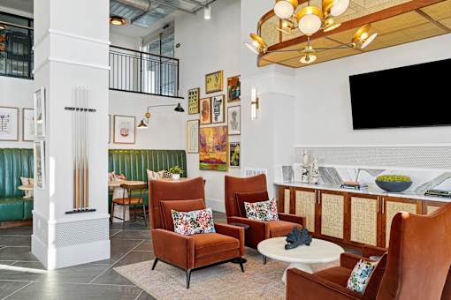 A living room with a white column and a green couch.