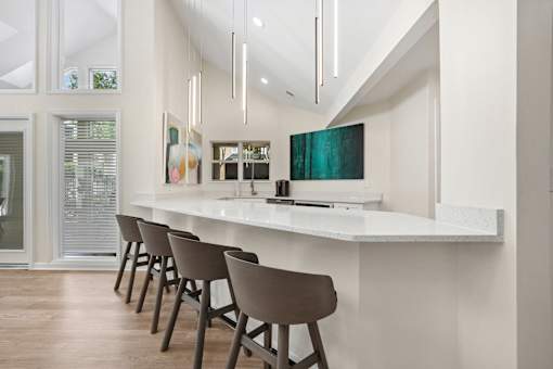 A row of brown chairs are lined up in front of a white counter.