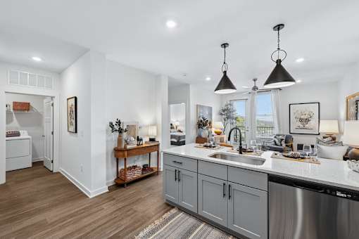 A modern kitchen with a large island and stainless steel appliances.