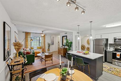A modern kitchen with a dining table and chairs.