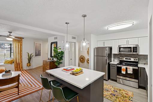 A modern kitchen with a dining table and chairs.