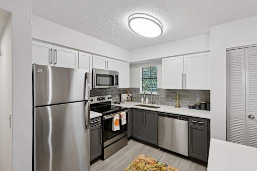 A kitchen with a stainless steel refrigerator and other appliances.