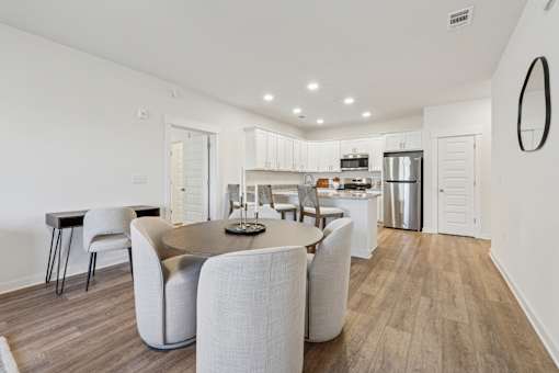 A modern dining room with a table set for six.