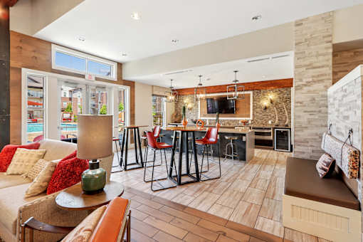 A living room with a couch, chairs, and a dining table.