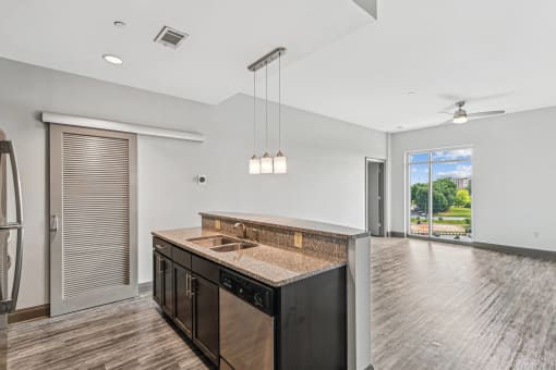 an open kitchen and living room with a large window and