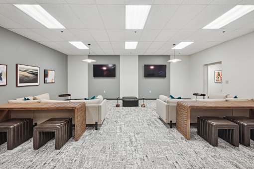 A conference room with a grey carpet and wooden furniture.