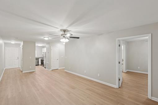 A room with a ceiling fan and lighting fixtures.