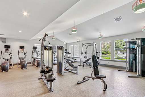 A spacious gym with a variety of equipment.