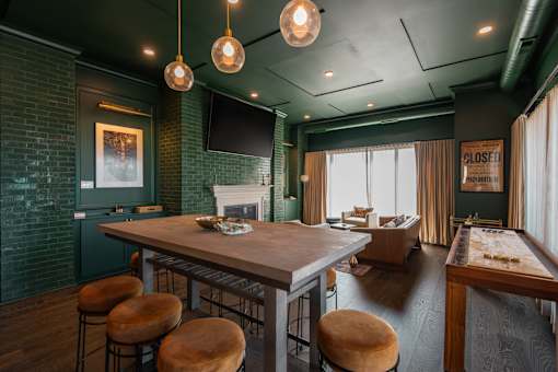 A room with a bar and a pool table.