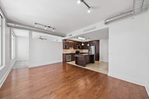 A kitchen with a wooden floor and white walls.
