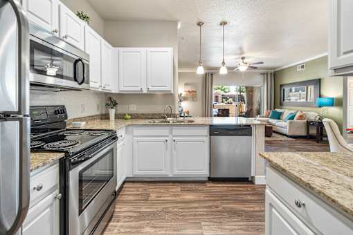 A kitchen with white cabinets and a granite countertop. at Stonebridge Ranch Apartments, Arizona, 85225