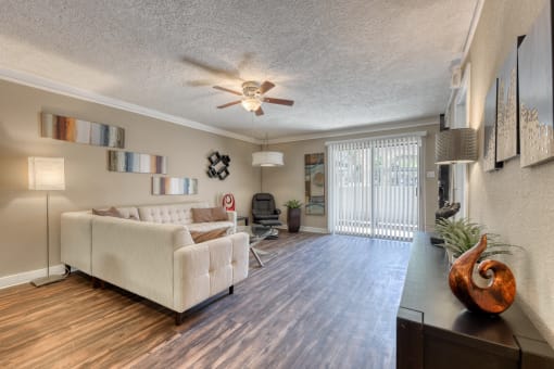 a living room with a couch and a ceiling fan