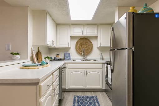 Kitchen with white cabinetry at Stride West, Albuquerque, NM