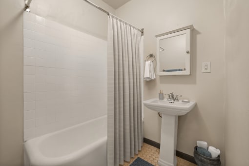 a small bathroom with a shower and a sink at Del Mor Apartments, California