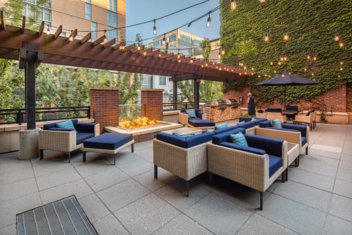 an outdoor patio with couches and a fire pit