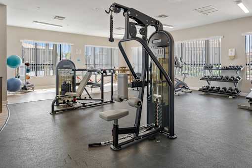 A gym with a variety of equipment including a leg press machine.