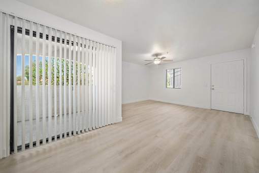 A room with a sliding door and a ceiling fan.