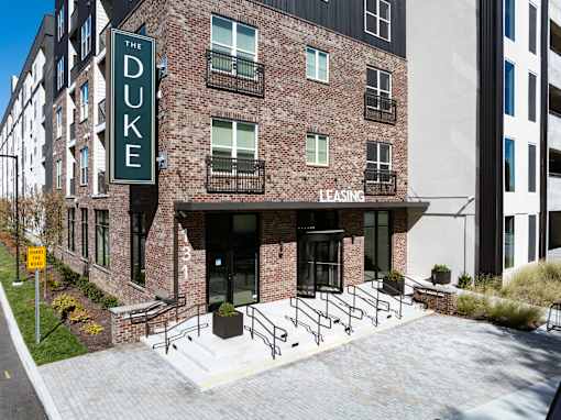 The Duke building is a brick apartment complex with a leasing office.