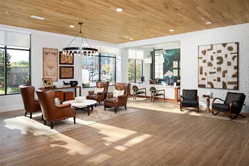 A living room with wooden floors and a variety of chairs.