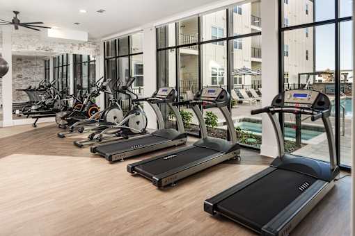 A gym with treadmills and exercise bikes.