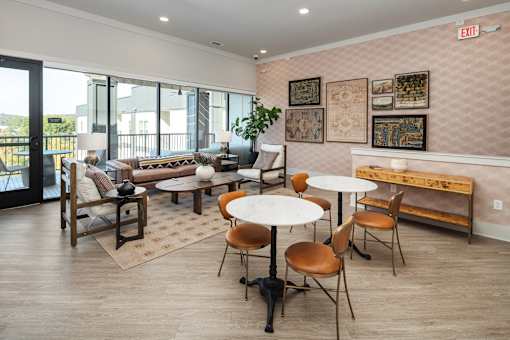 A room with a white table and chairs and a brown bench.