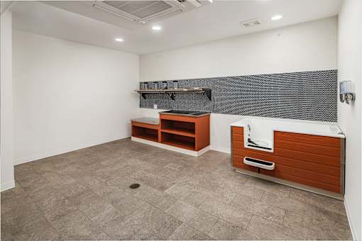 A bathroom with a tiled floor and a wooden vanity.