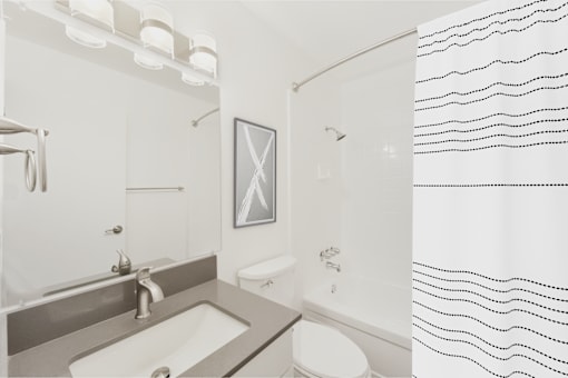 A bathroom with a sink, toilet, and shower.