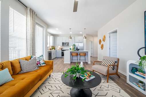 A living room with a sofa, a table, and a chair.