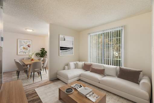 A living room with a white couch and a coffee table.