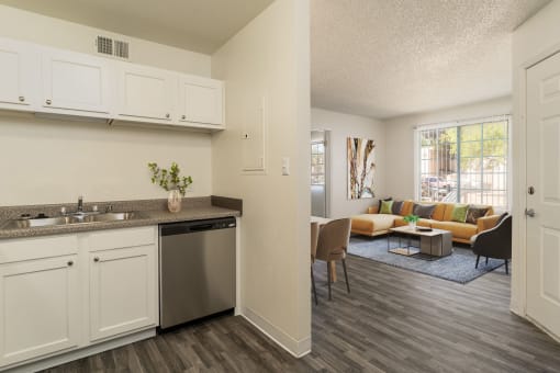 an open kitchen and living room with a couch and a table