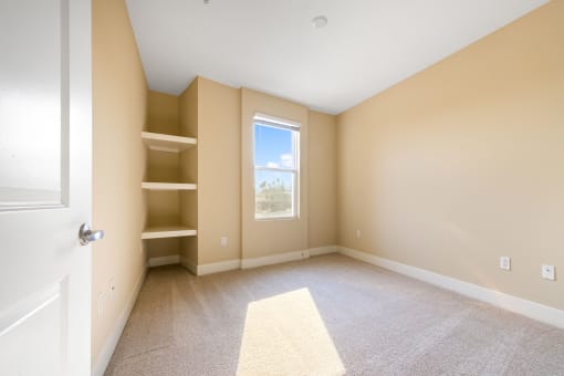 a bedroom with beige walls and a window
