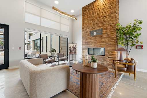 A living room with a white sofa and a wooden coffee table.