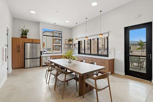 A modern kitchen with a dining table and chairs.