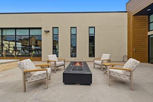 A patio with a table and chairs is set up outside a building.