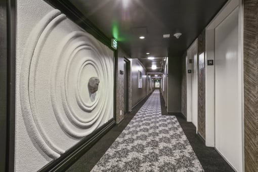 a row of ammonite coils on a wall in a hallway of a hotel room