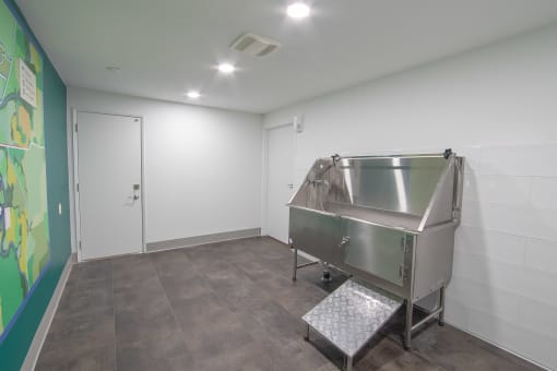 a large stainless steel tub sits in the corner of a room with a green mural on the at Veri at Timberhill, Oregon